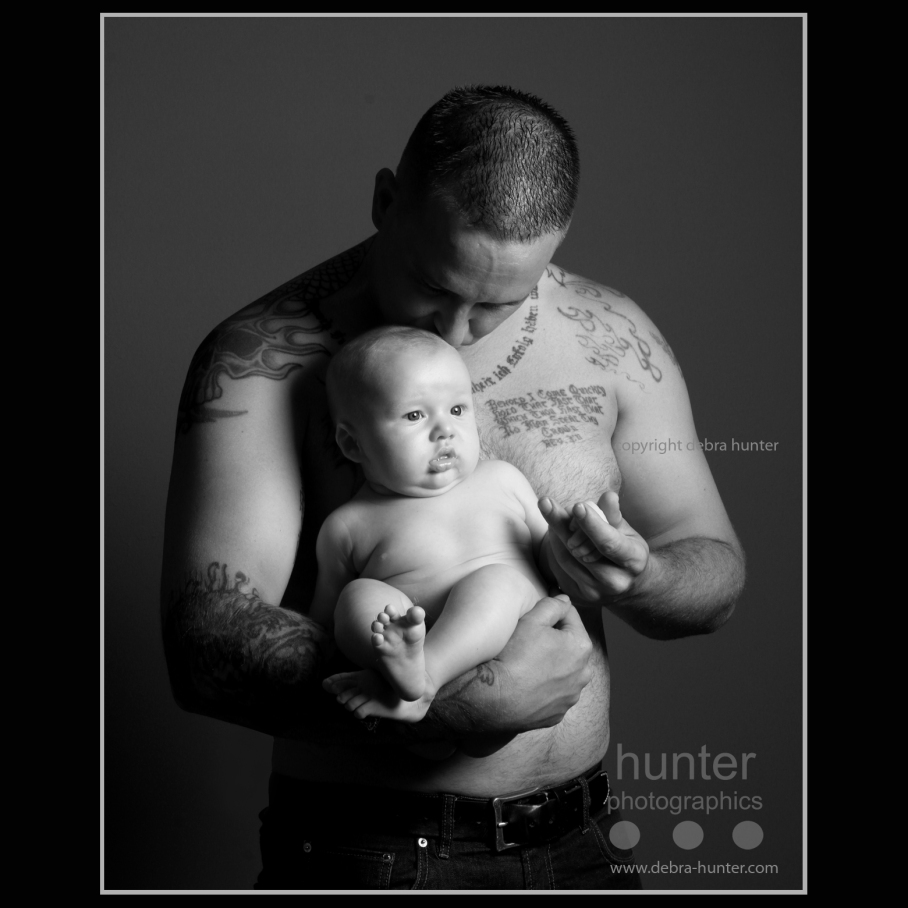 Portrait of father, son and tattoos in black and white.